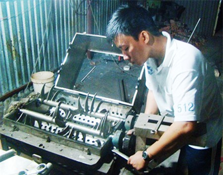 Võ Đông Phú đang bảo trì chiếc máy tán bột