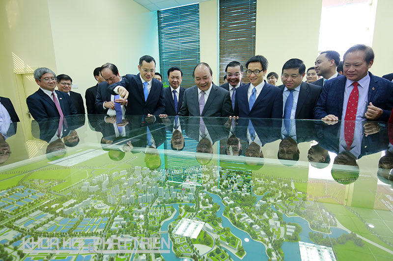 Thủ tướng Nguyễn Xuân Phúc (thứ ba từ trái qua), Phó Thủ tướng Vũ Đức Đam (thứ tư từ trái qua) cùng các đại biểu vui mừng khi nghe Trưởng ban quản lý Khu CNC Hòa Lạc  cho biết hiện đã có 78 dự án đầu tư vào Khu CNC Hòa Lạc.