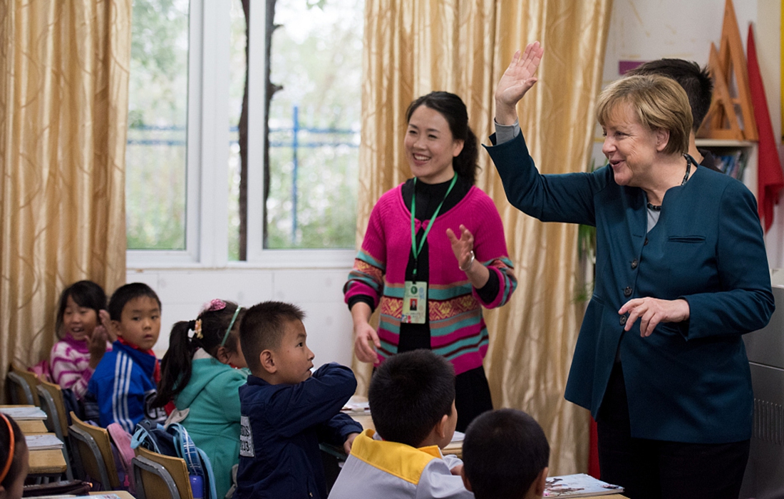 Nguyên Thủ tướng Đức Angela Merkel đến một trường học ở Hồ Bắc, Trung Quốc. Ảnh: AFP