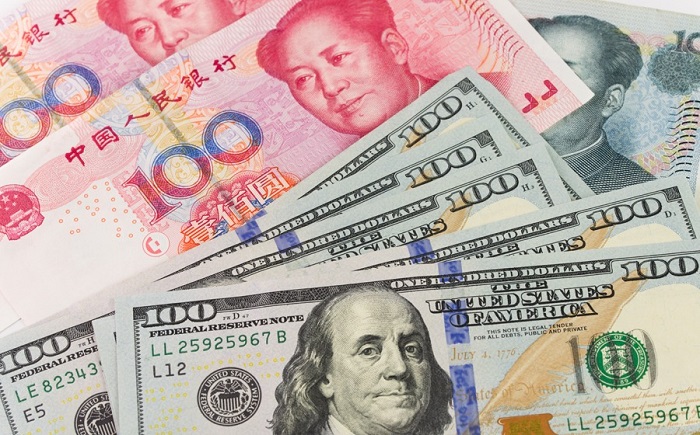 Đồng đô la Mỹ và nhân dân tệ Trung Quốc. Ảnh minh họa: Capital