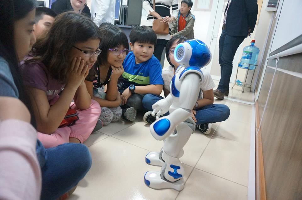 Các em học sinh tương tác với Robot NAO (Pháp) trong Ngày hội STEM 2017 tại Trường ĐH KH&CN Hà Nội. Ảnh: Hảo Linh
